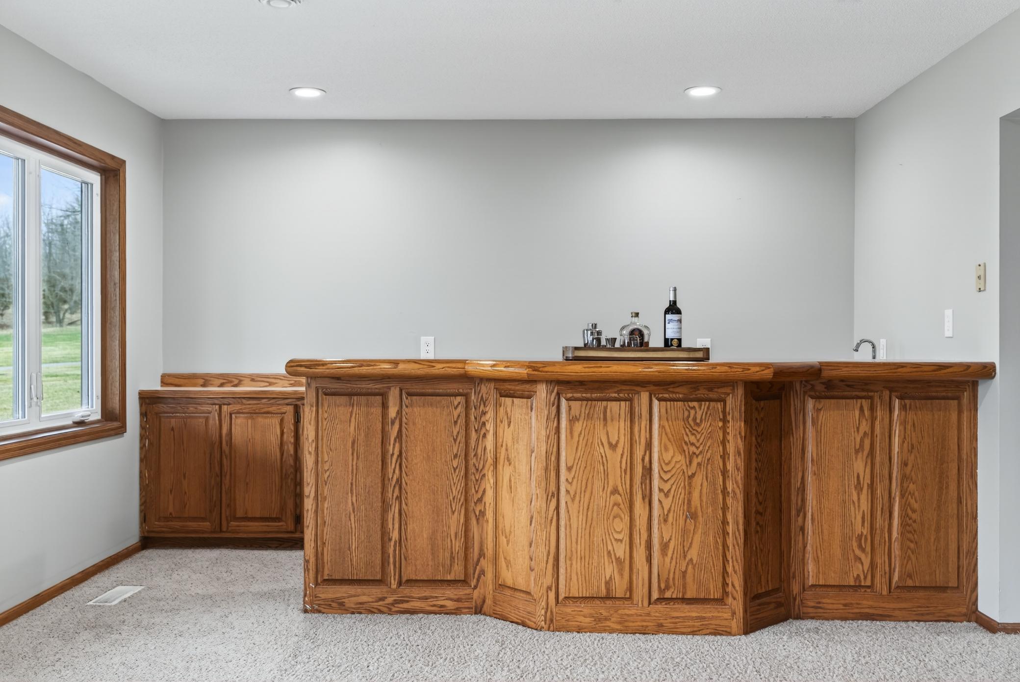 Close-up view of the basement wet bar with mini-fridge.