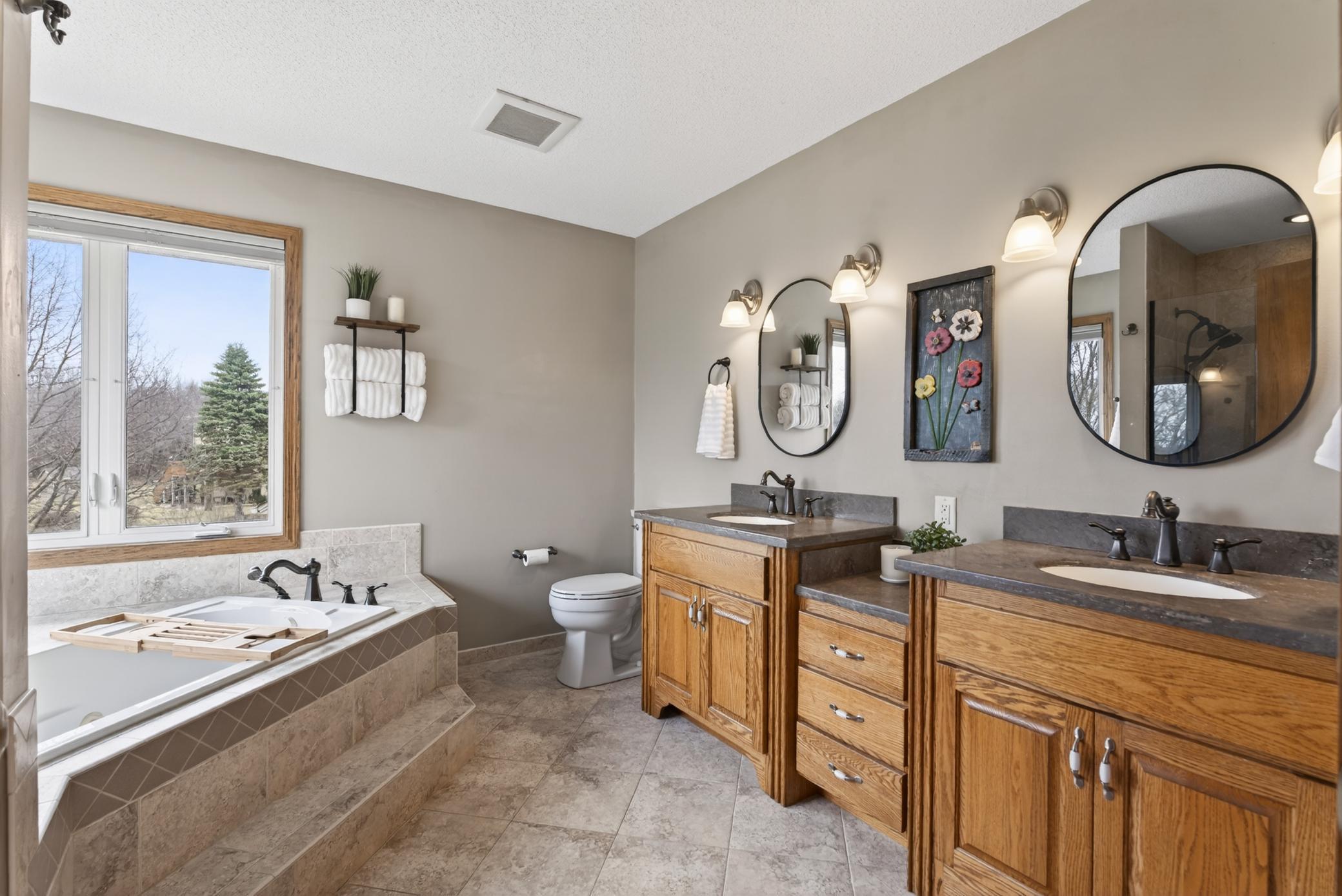 Primary bathroom with heated floors, double sinks, soaking tub and walk-in shower.
