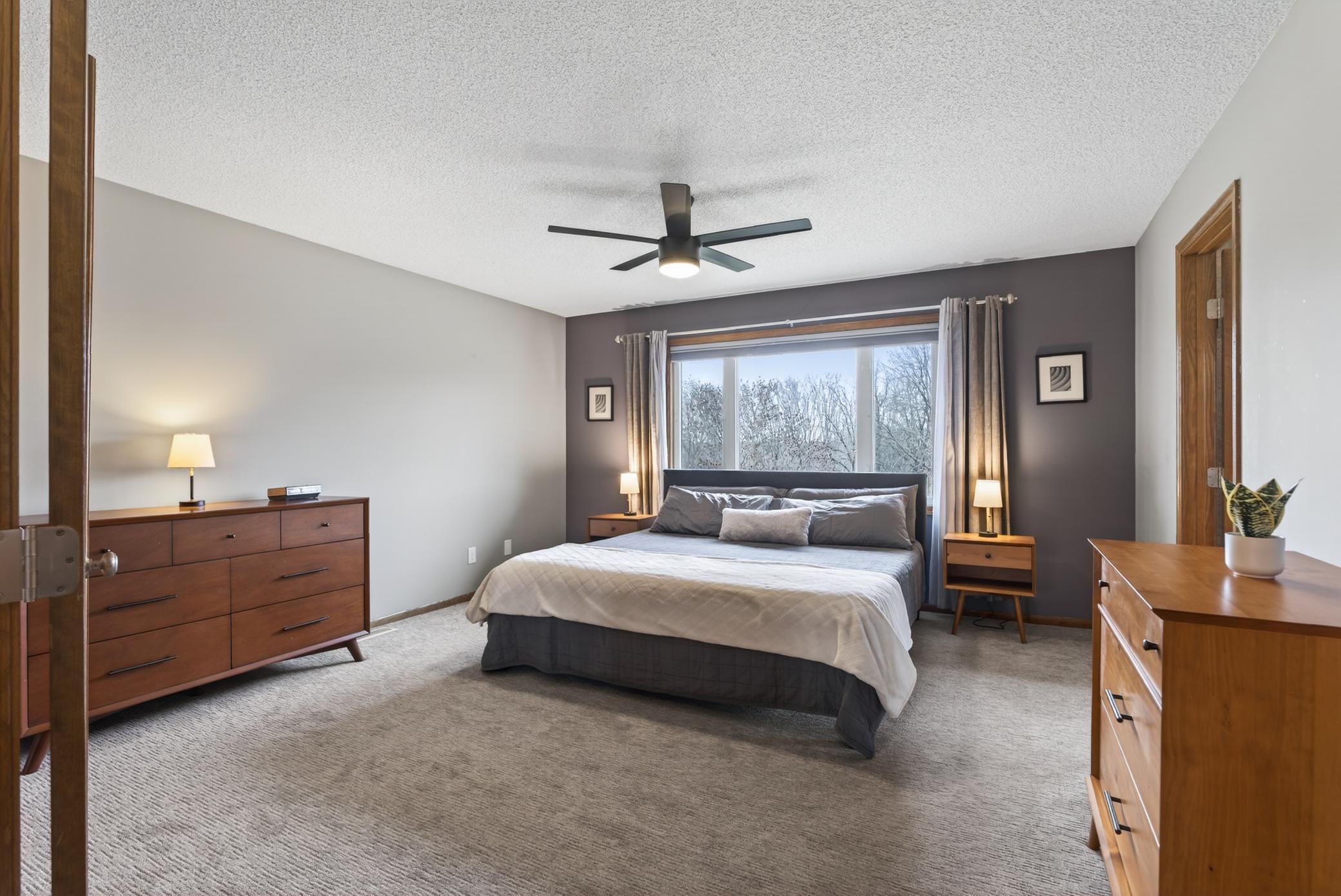 Upper level primary suite with views of Elm Creek Park.