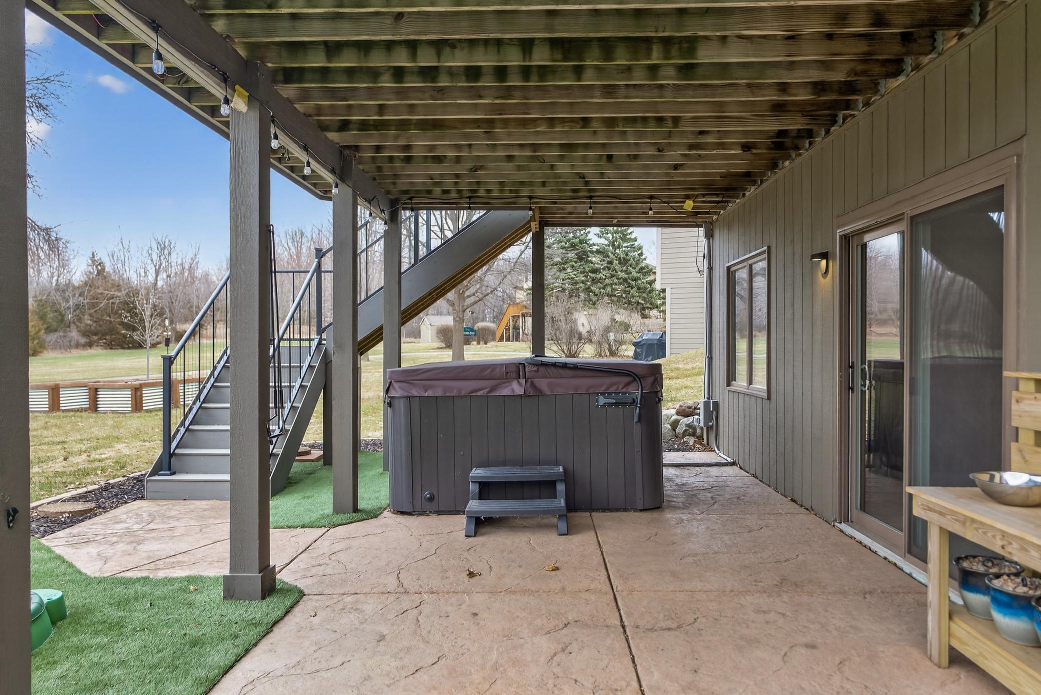 Additional privacy/sun screens pull down for hot tub on patio.