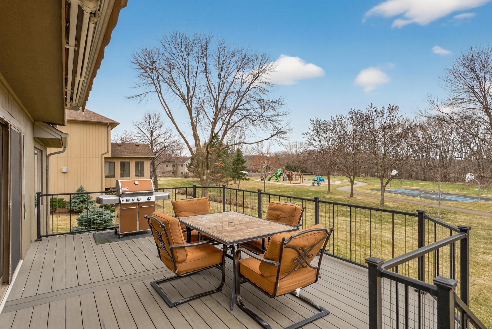 Maintenance-free deck with sun-shade and views of the playground and woods.