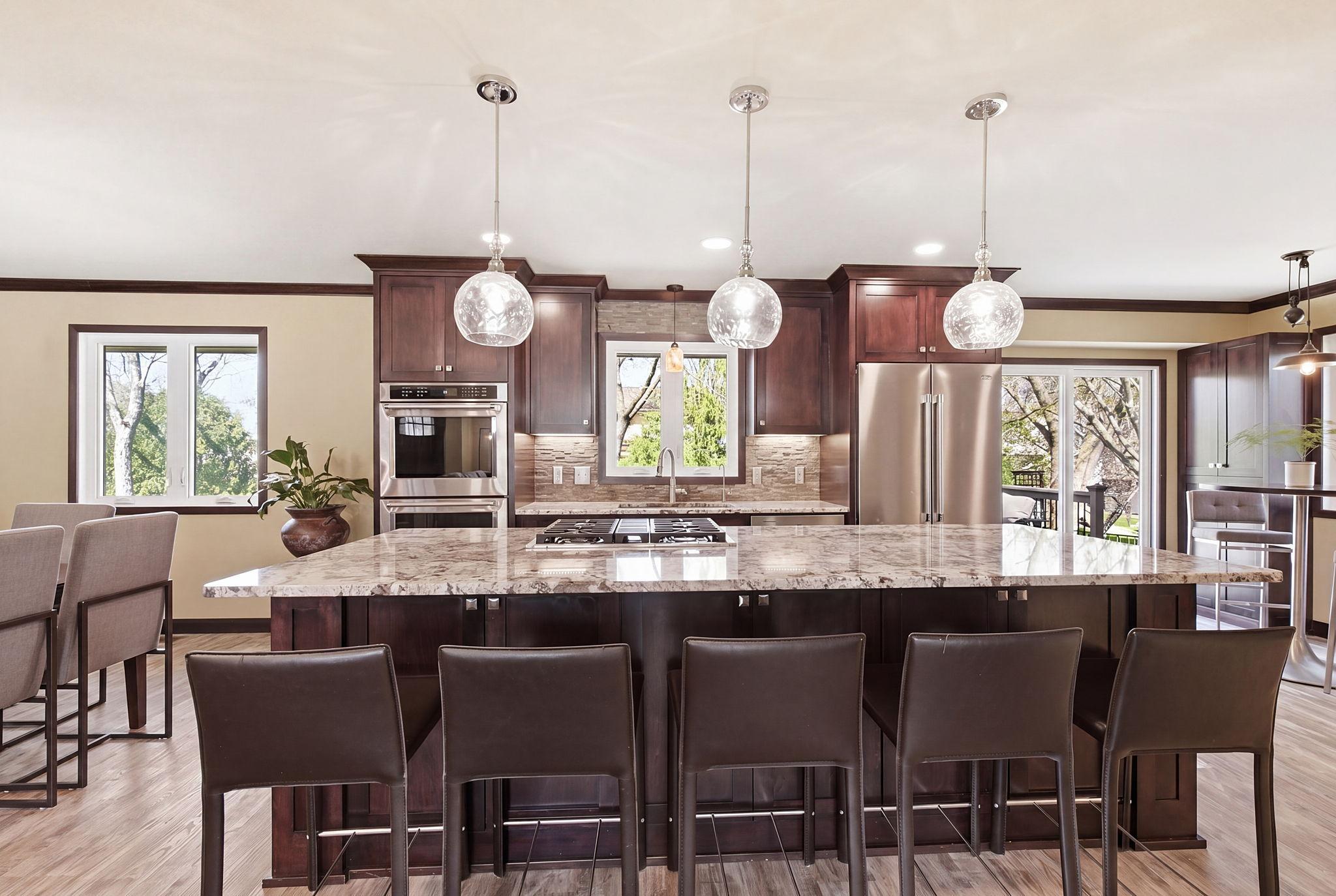 Custom kitchen cabinetry with expansive island and seating for five