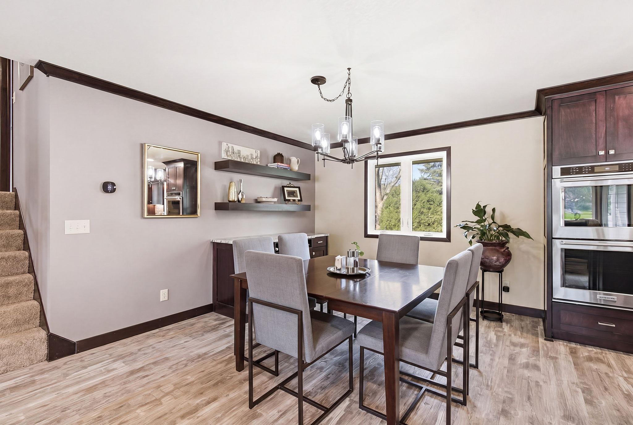 Dining area with built in custom cabinetry and floating shelves