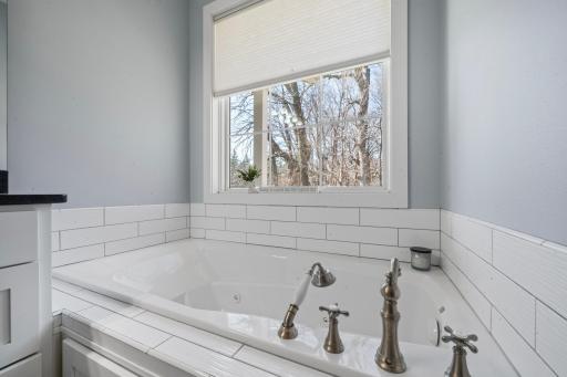 The master suite includes a relaxing jet tub, offering a spa-like retreat perfect for unwinding at the end of the day.