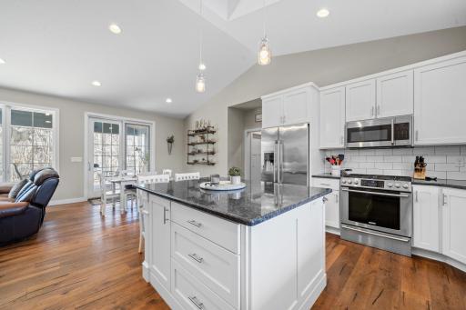 The kitchenâs spacious design is complemented by an abundance of windows that fill the room with light.