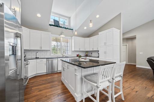 Sunlight pours into the large kitchen, highlighting its generous layout and welcoming atmosphere.