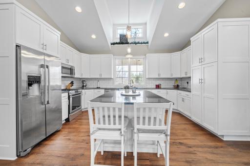 With its expansive layout, distinctive ceilings, and sunlit ambiance, the kitchen becomes a true focal point of the home.