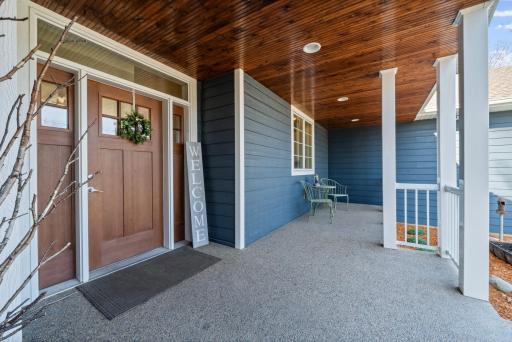Enjoy the front porch featuring beautifully wood-accented ceilings.