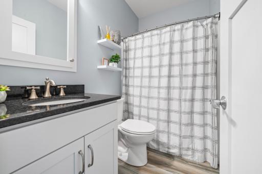 The main-level bathroom is generously sized, offering a comfortable and convenient space for guests.