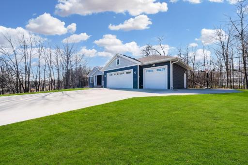 The garage offers two stalls separated by a dividing wall, along with a third stall on its own, providing flexible parking and storage options.