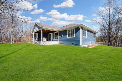 Bask in the natural light on this welcoming back porch.