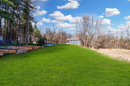 The expansive yard offers endless possibilities for outdoor enjoyment, from lively gatherings and games to cozy bonfires under the stars.