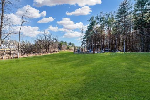The generous yard creates the perfect setting for outdoor enjoyment, whether hosting gatherings, playing games, or gathering around a warm bonfire on cool evenings.