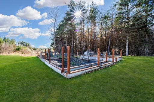 Thoughtfully placed garden beds provide a perfect opportunity to grow flowers, herbs, or vegetables, adding both beauty and function to the outdoor space.