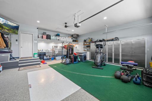 The upgraded garage features durable epoxy flooring, providing a clean, polished look along with enhanced durability and easy maintenance.