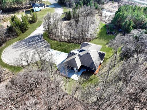Nestled among private woods, the home enjoys a quiet, secluded feel with a serene wooded setting.