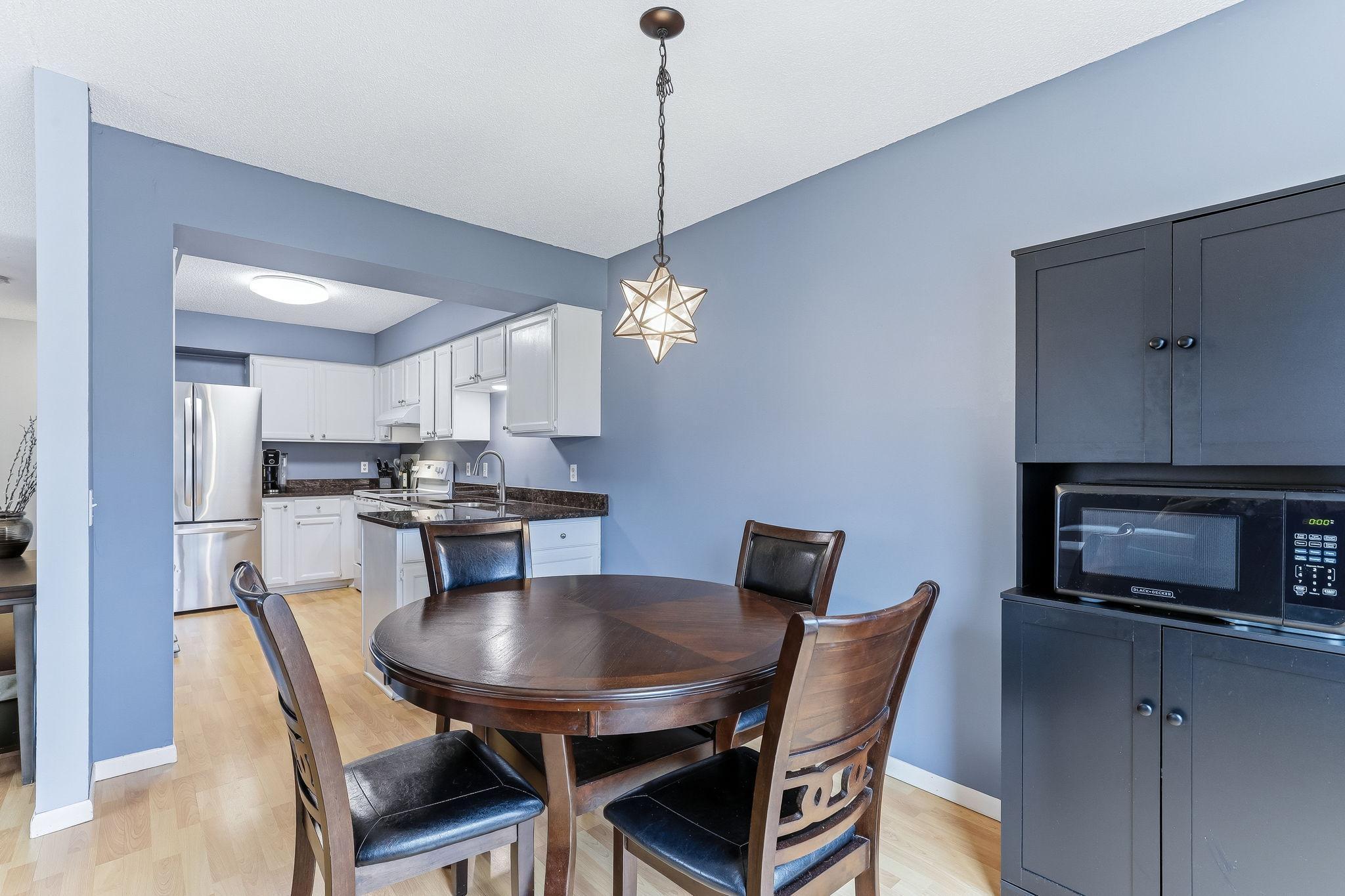 Functional dining space with direct connection to the kitchen, creating a practical layout for meals, hosting, and daily use.