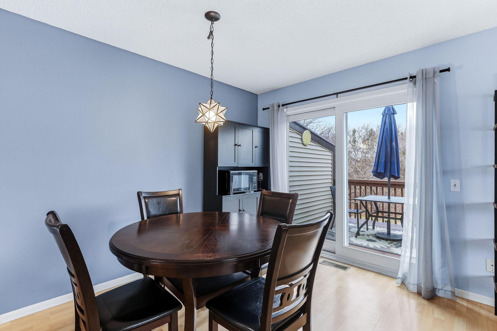 Dining area with a sliding glass door leading to the deck, allowing for easy indoor-outdoor living and natural light throughout the space.