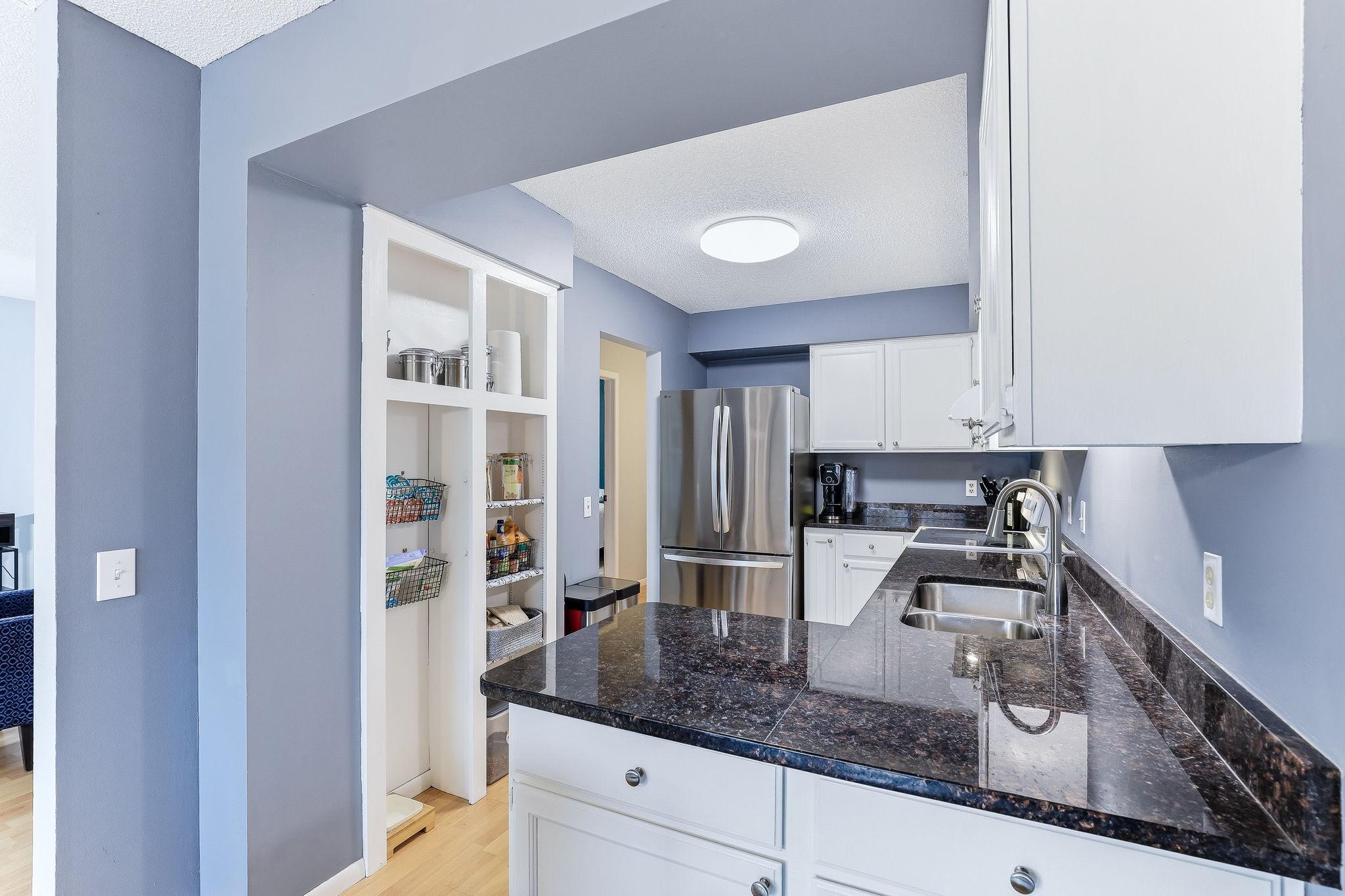 Functional kitchen with peninsula seating, ample cabinetry, and built-in storage, designed for efficiency and everyday convenience.