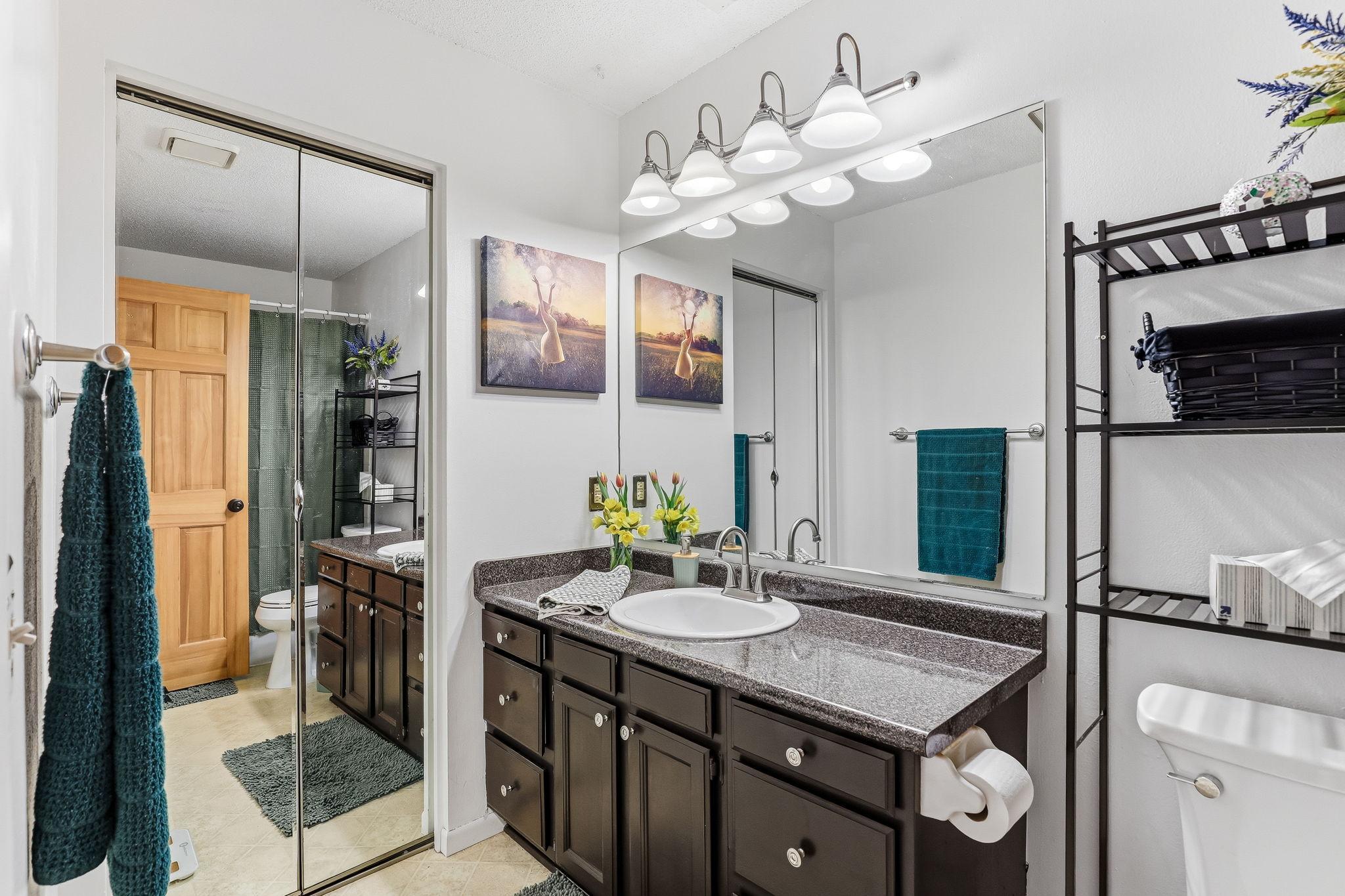 Well-maintained bathroom with extended vanity, ample counter space, and bright lighting for everyday use.