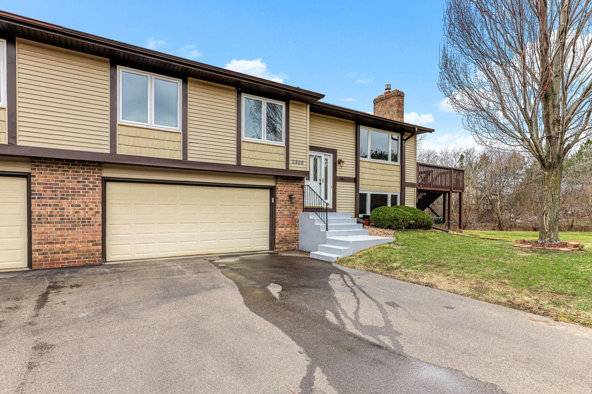 Angled front view highlighting extended driveway space, clean exterior, and separation from neighboring units for a more open, private feel.