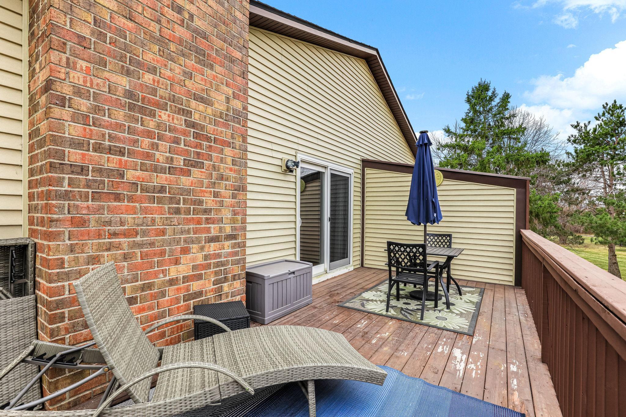 Spacious deck with multiple seating areas, ideal for relaxing or entertaining while enjoying open views and added privacy.
