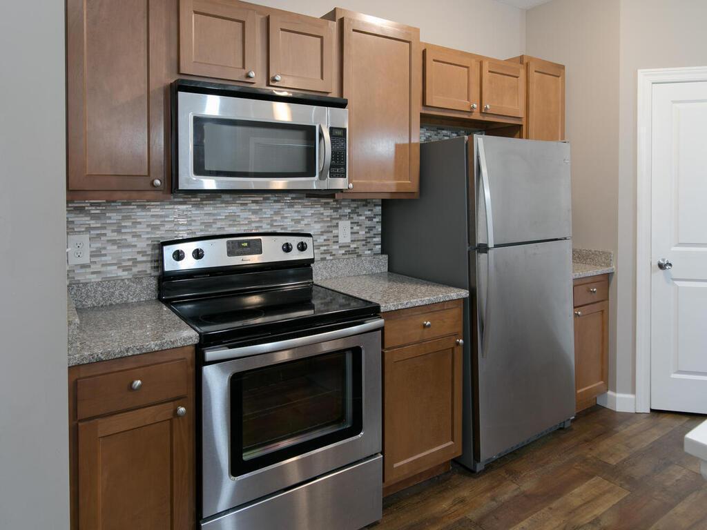 Stainless steel appliances, tile backsplash and an abundance of cabinets.