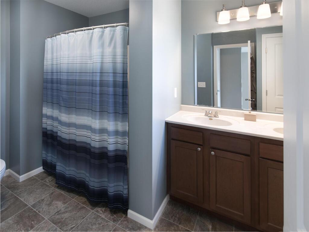 The primary bath en-suite features double vanities, large linen closet and a full shower/tub.