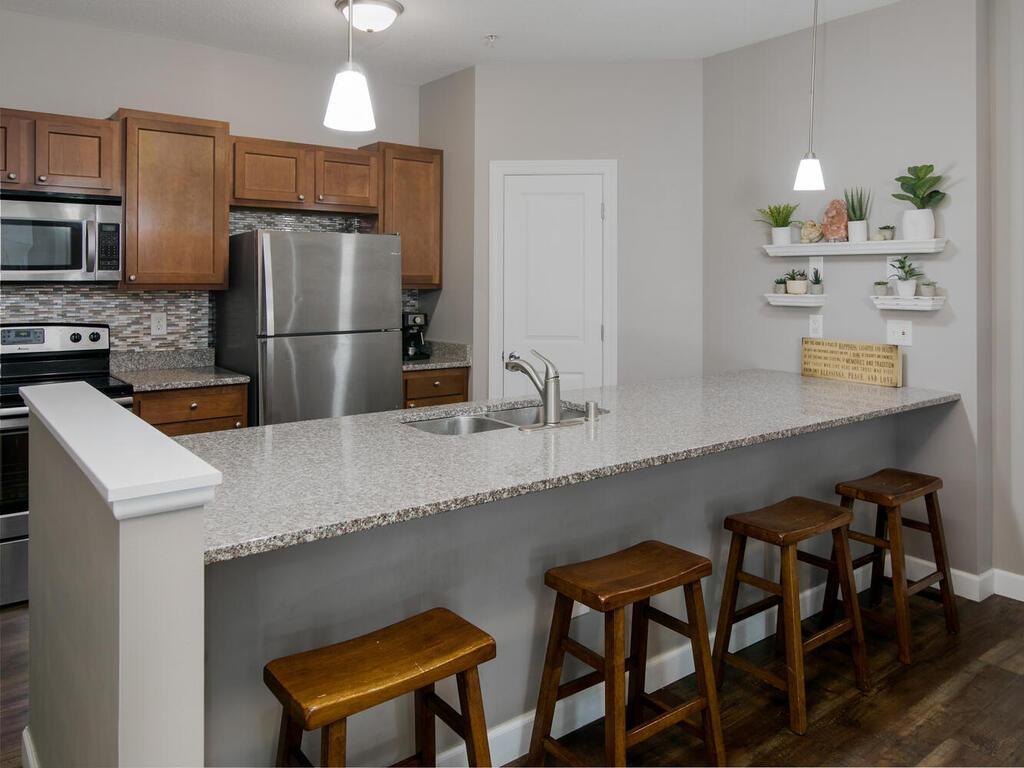 Impressive kitchen with granite countertops, large breakfast bar, and walk in pantry.