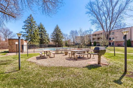 Courtyard area with picnic tables, grill and heated pool.