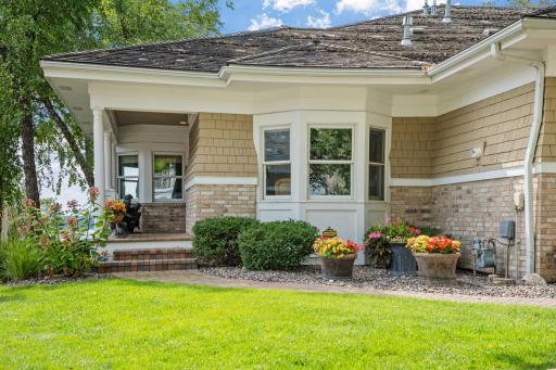 Charming covered front porch entry ~ cedar shake siding w/ brick accents!