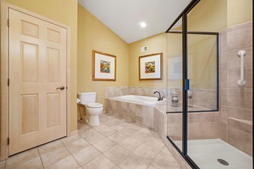 Jetted tub situated on a ceramic tile deck and surround. Vaulted ceilings!
