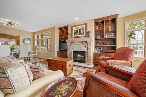 Pair of rustic alder built-in entertainment cabinets offer storage, area for TV and open display shelving w/ interior accent lighting