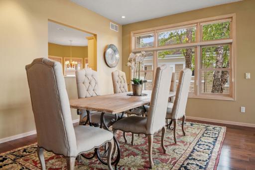 Passthrough opening to the kitchen and Saddle Black Walnut hardwood flooring