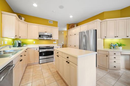 GE Profile stainless steel appliances include French door refrigerator, slide-in electric range, dishwasher and microwave