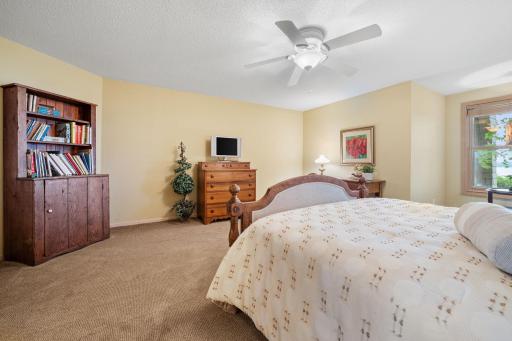 Bedroom 2 features walk-in closet w/ mirrored doors and ceiling fan