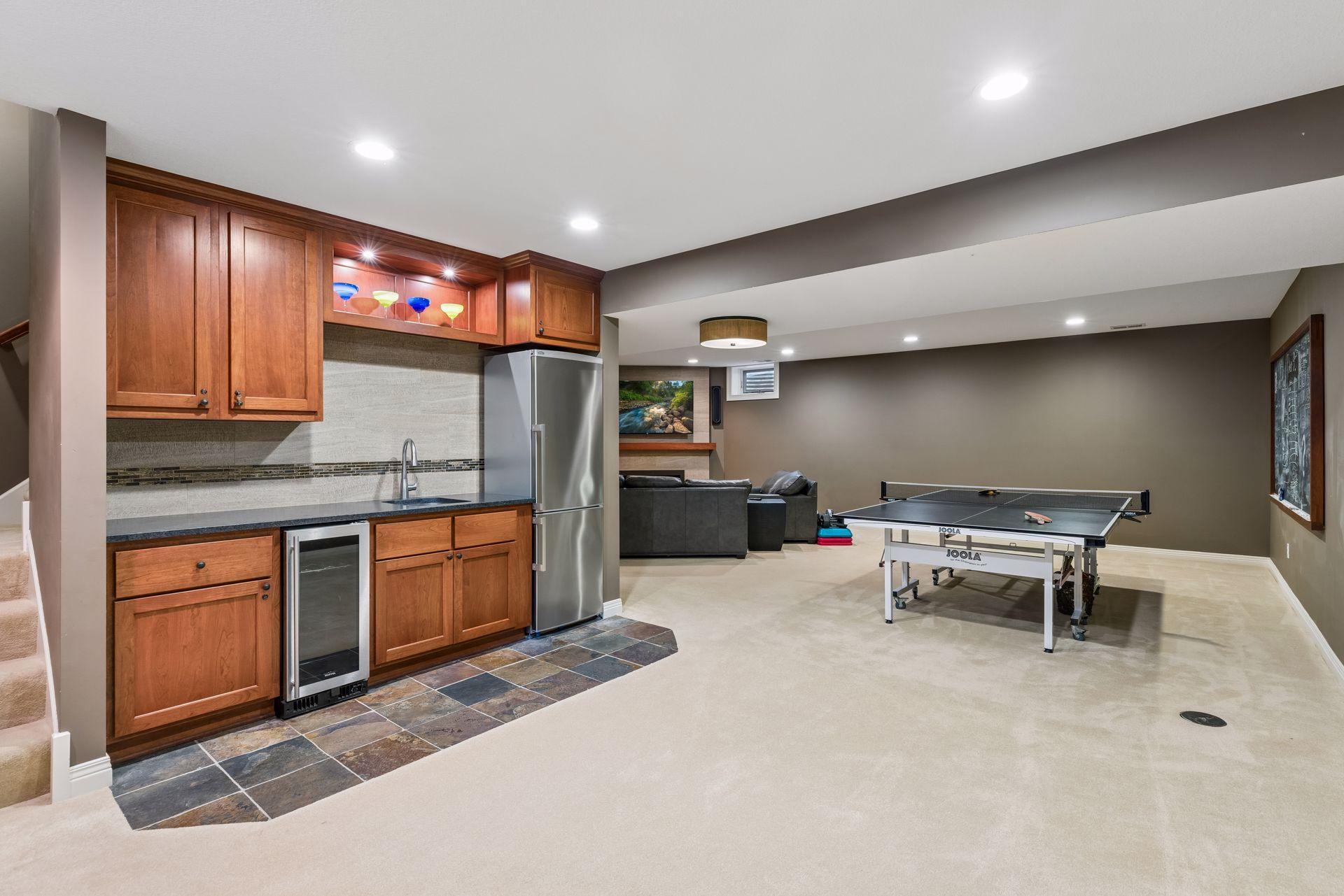 Lower level entertainment space with wet bar, wine refrigerator, and add'l refrigerator.