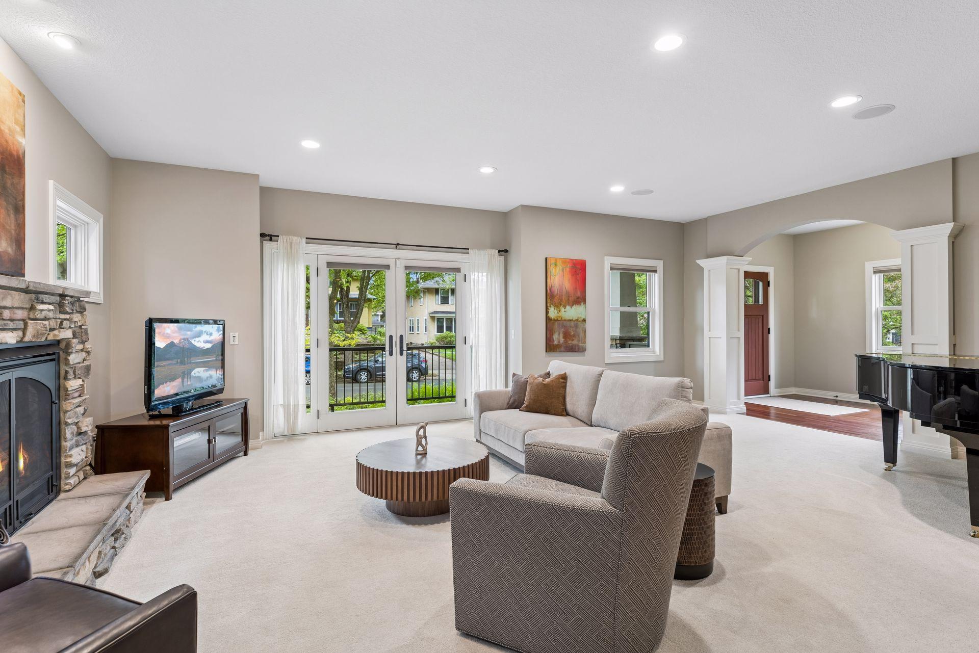 Inviting living room with sliding doors to the enclosed front balcony deck.