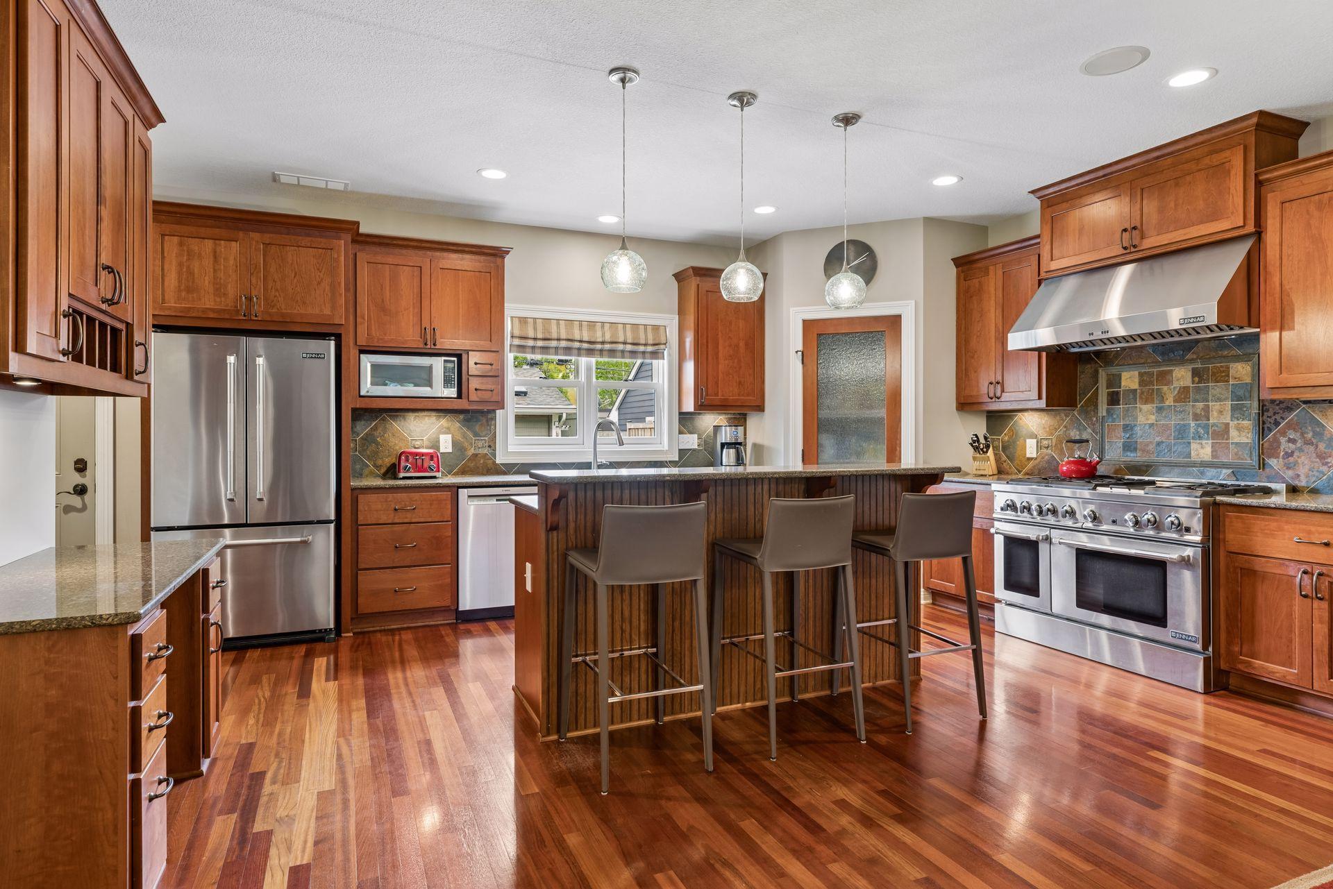 Chef's kitchen with Jenn-Air gas stove and cherry cabinets.