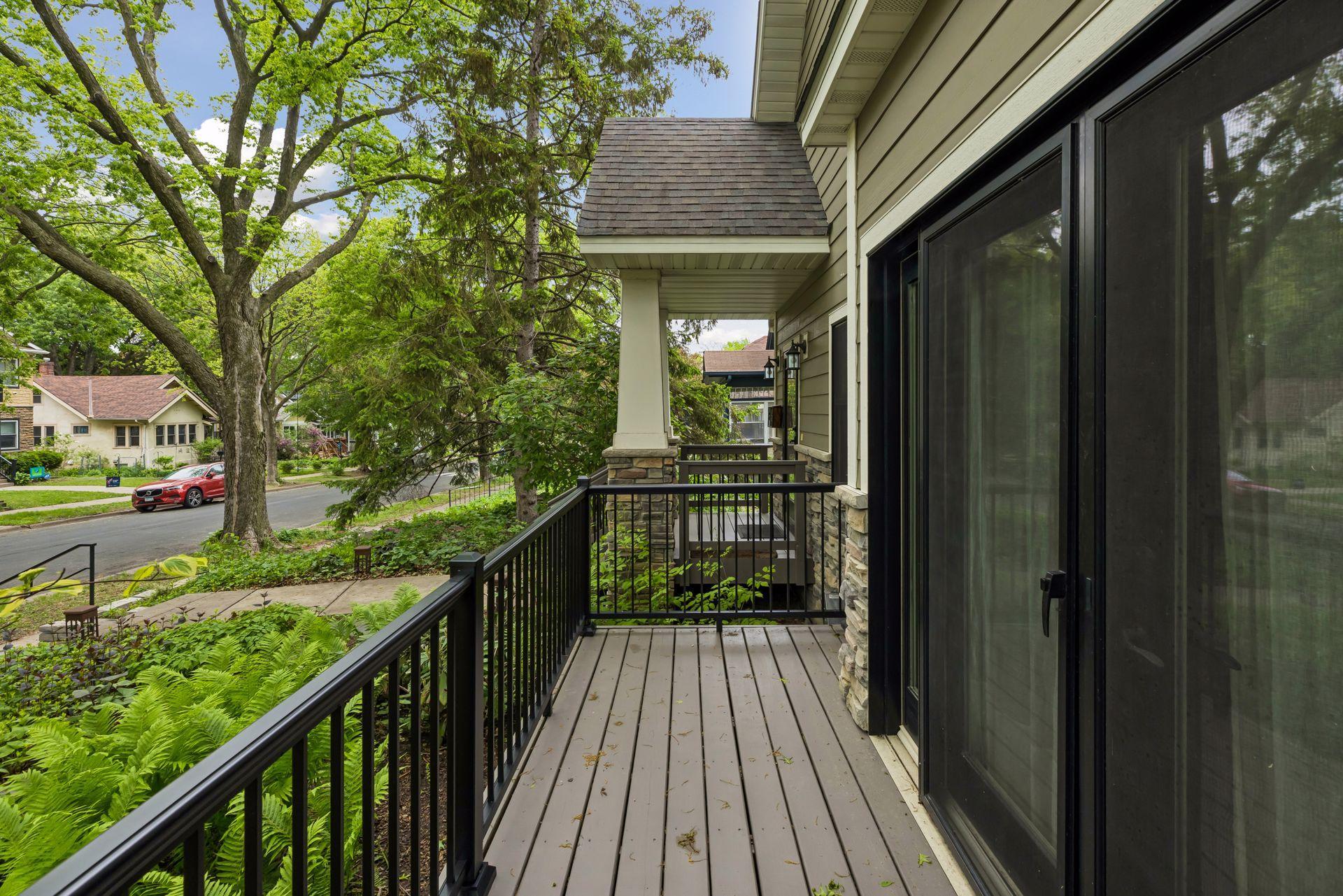 Enclosed balcony front porch overlooking the front perennial garden.