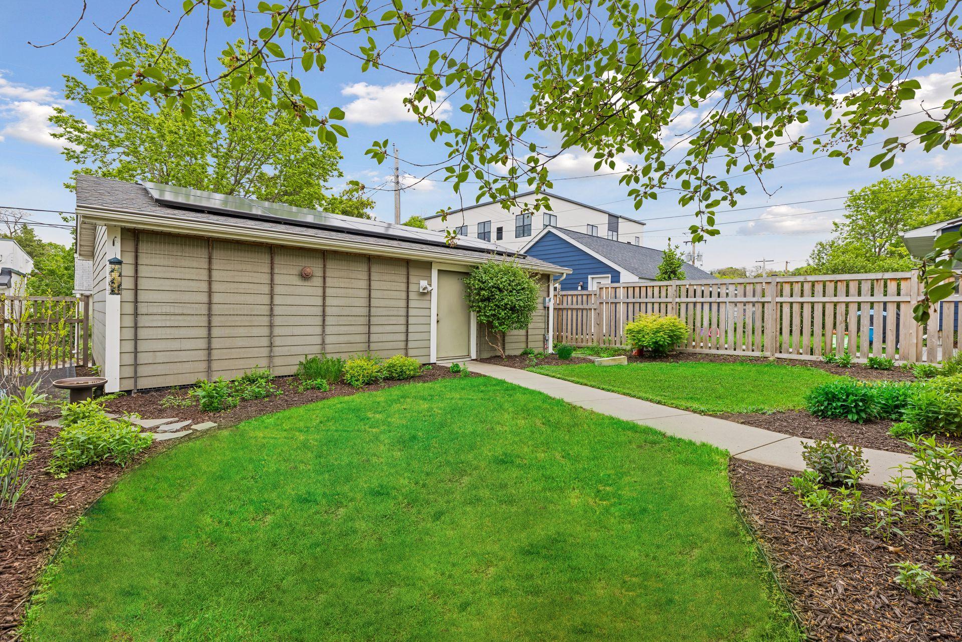 Here's the backyard entrance from the 3-car garage. A charming backyard!