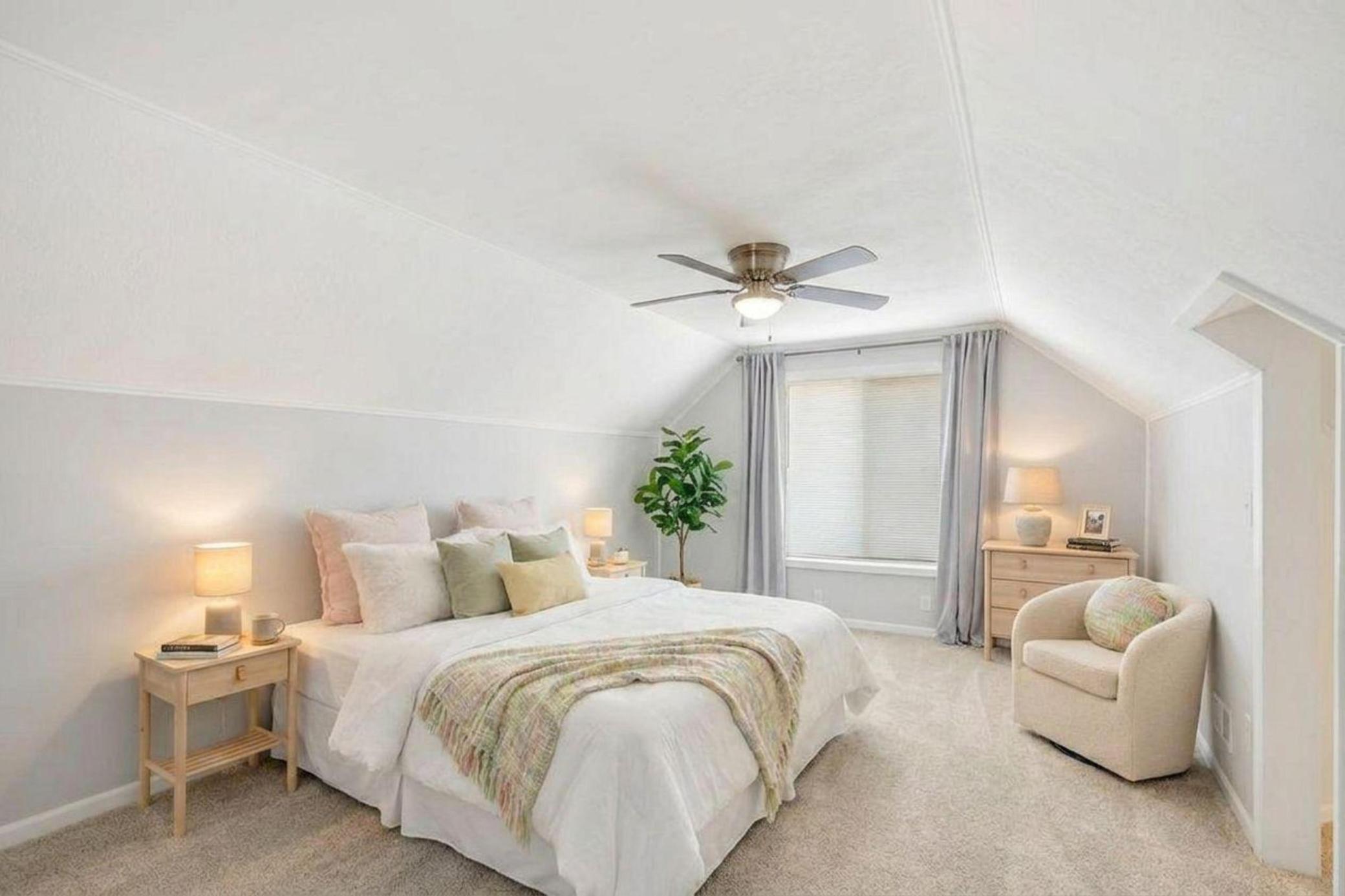 Staged upper level bedroom with great ceiling height!