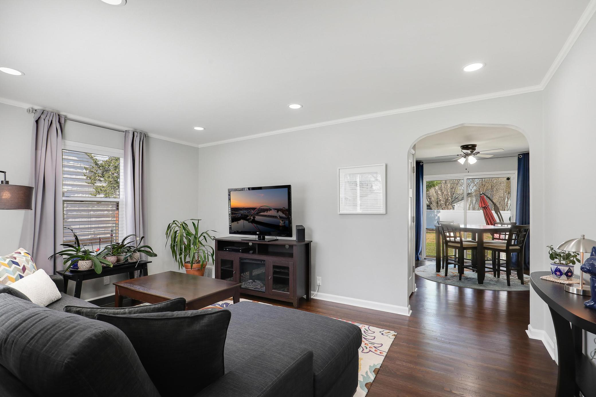 The view from the front door all the way to the backyard - the home is filled with natural light! Original hardwood floors, arched doorways, crown molding, white trim and recessed lighting too!