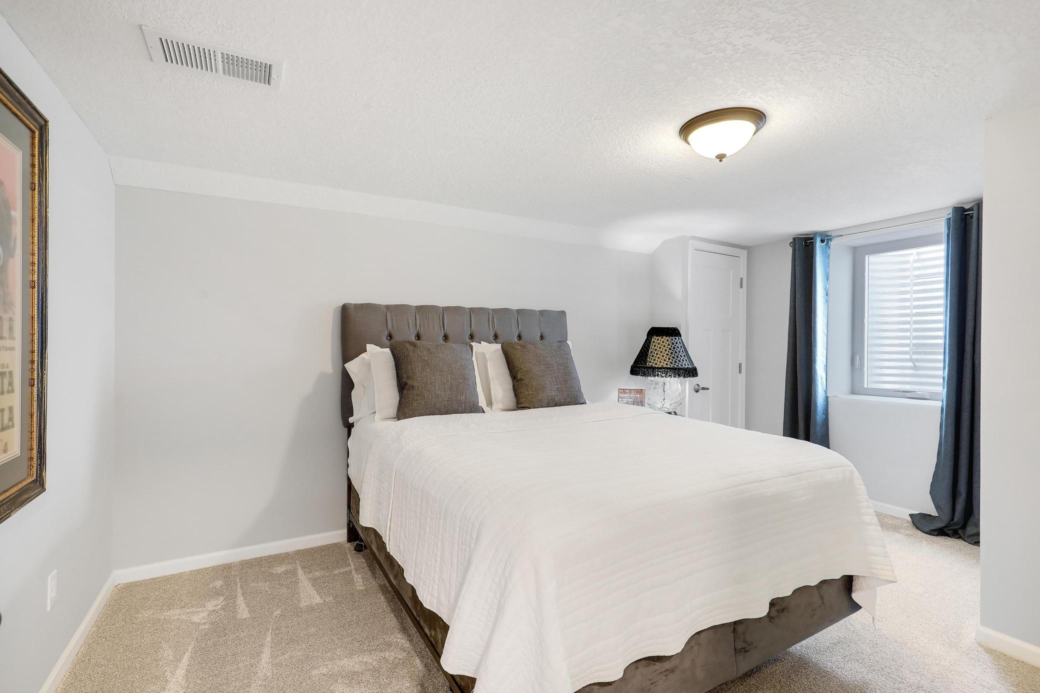 Lower level fifth bedroom. Both lower level bedrooms are legal due to an egress window and closets.