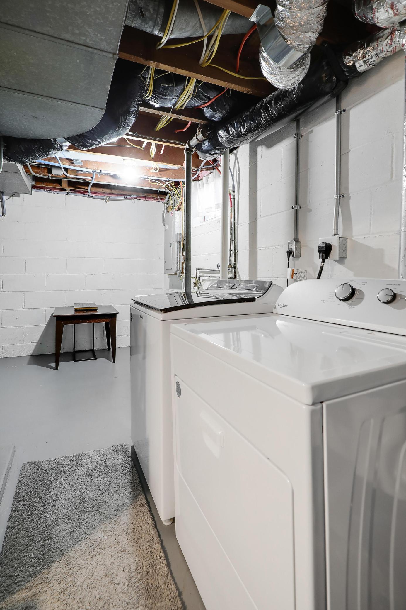 Laundry room offers newer appliances and offers a sink as well.