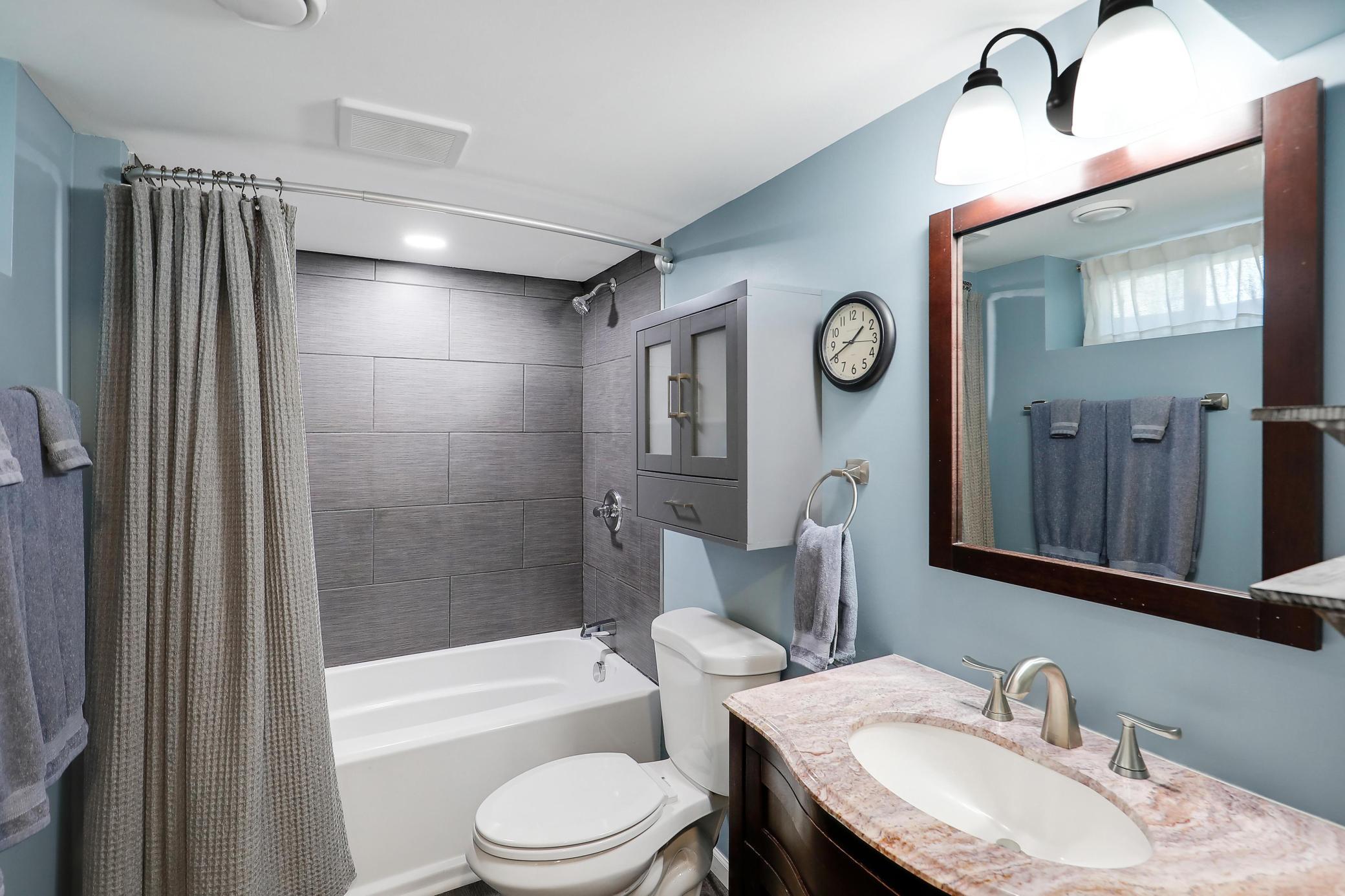 Private primary bathroom with tile surround and flooring and a soaking tub!