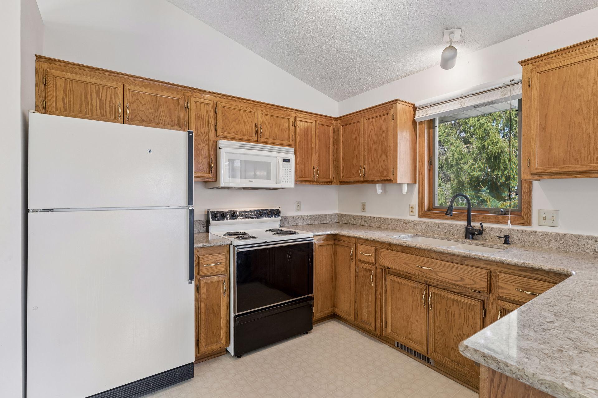Sunlight streams through the large kitchen window