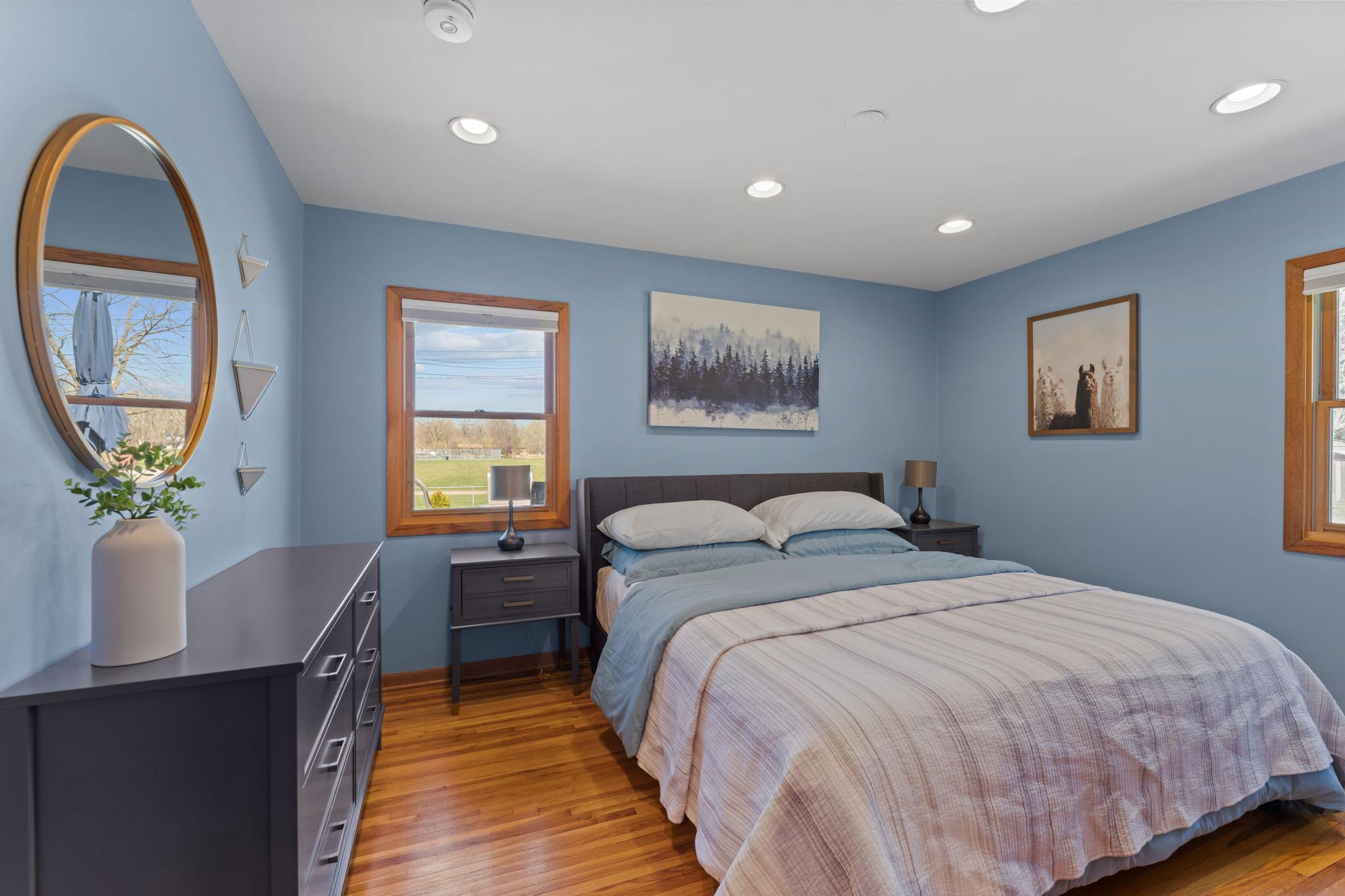 The main-level primary bedroom is more spacious than it appears, offering a comfortable and open feel.