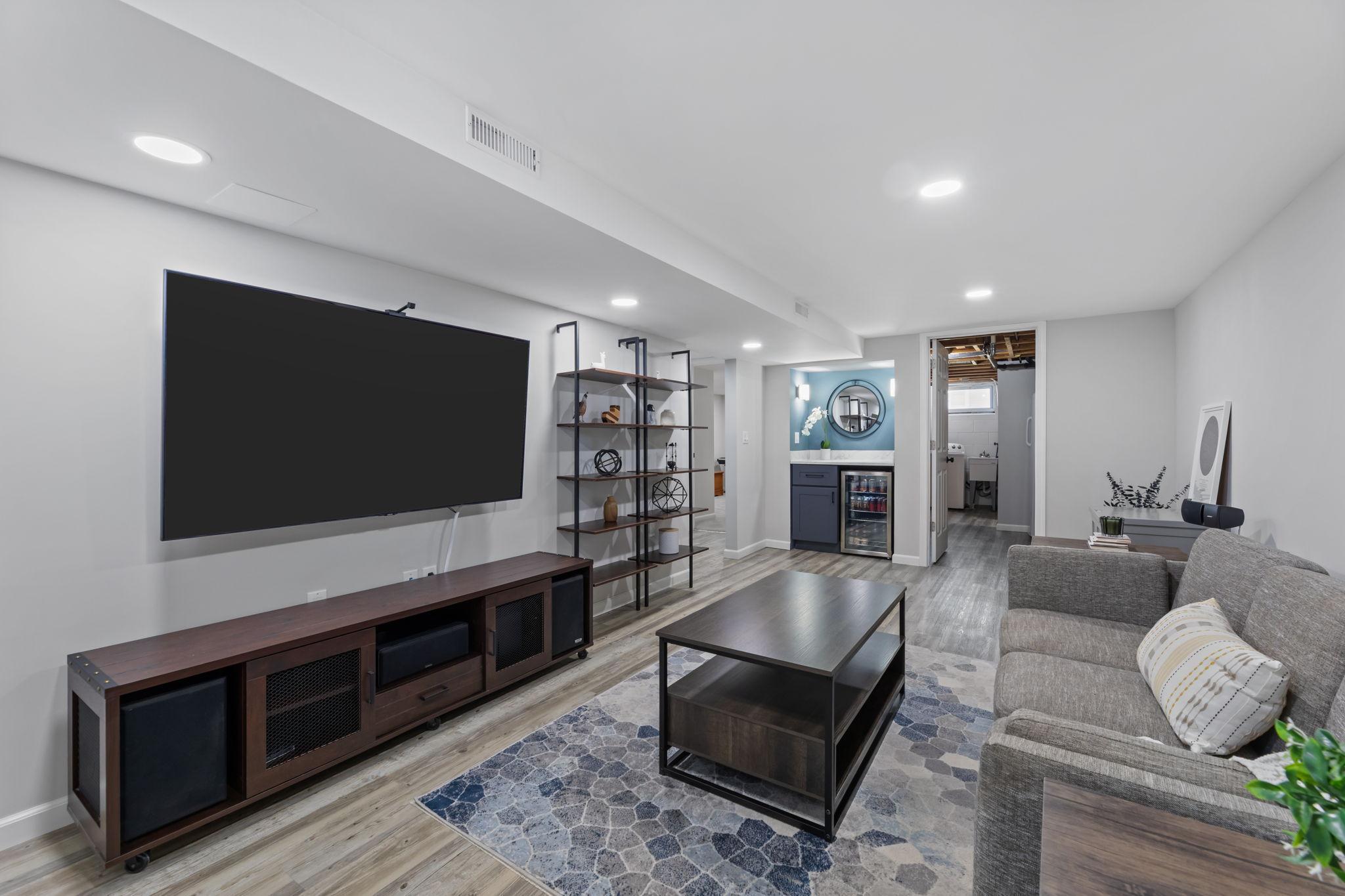 The lower level includes a dry bar with mini fridge, ideal for entertaining.