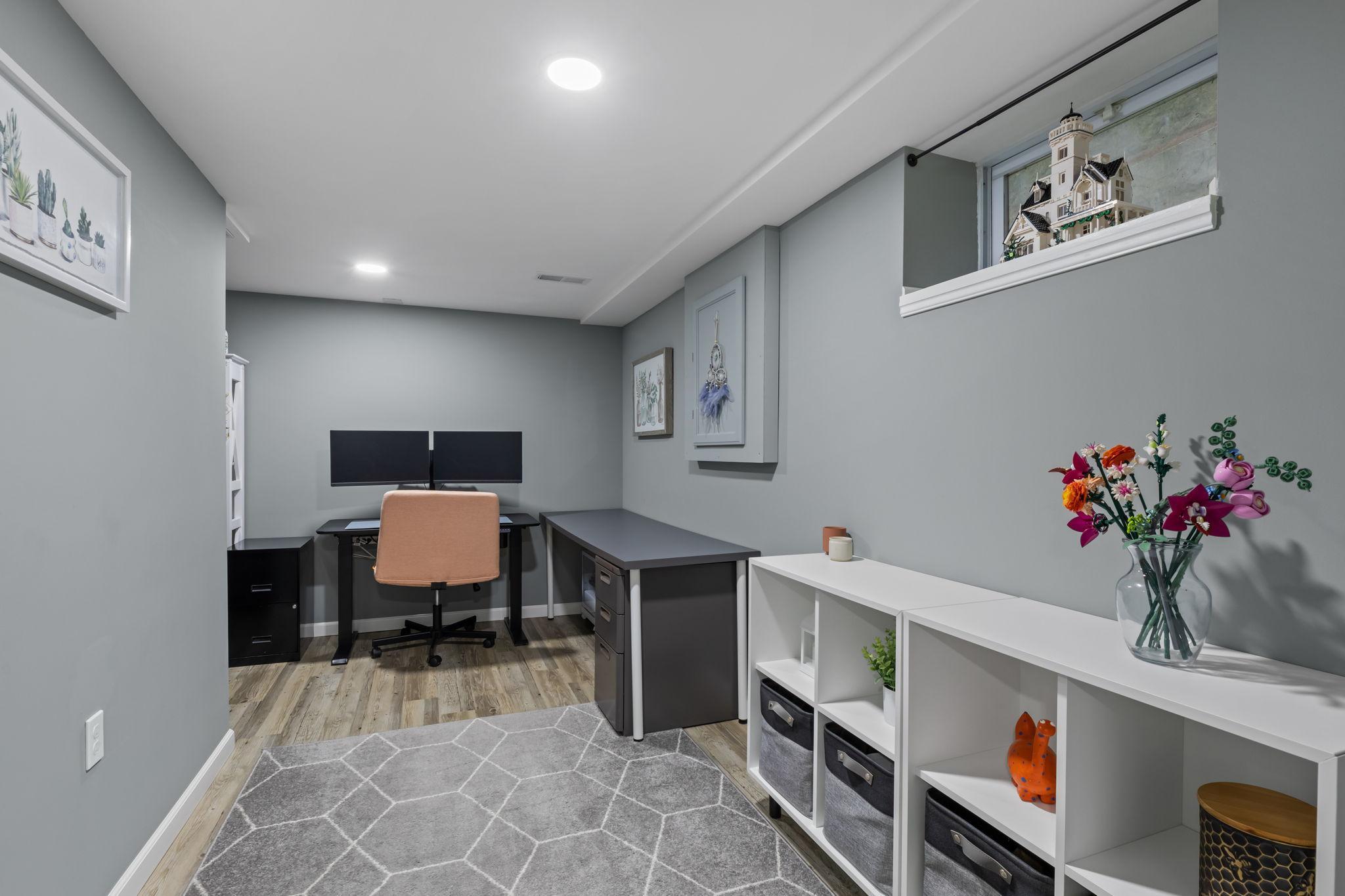 The spacious lower-level office offers a quiet retreat, complete with a cozy reading nook tucked into the back corner.